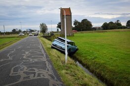 Auto ramt lantaarnpaal en belandt boven sloot in de greppel